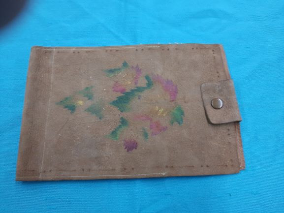 A leather wallet with a faded pattern.