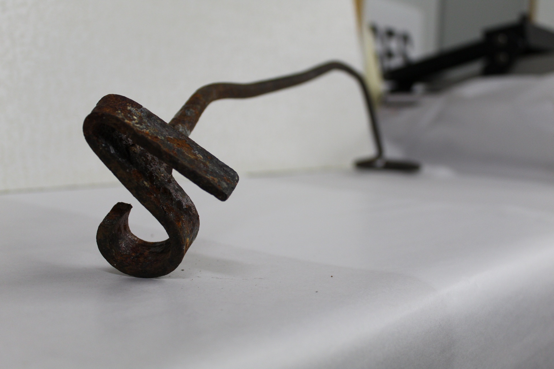 Branding iron with an ambiguous symbol on it.