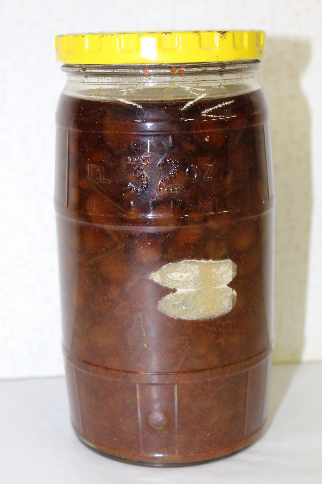 An old jar of kidney beans with a yellow lid.